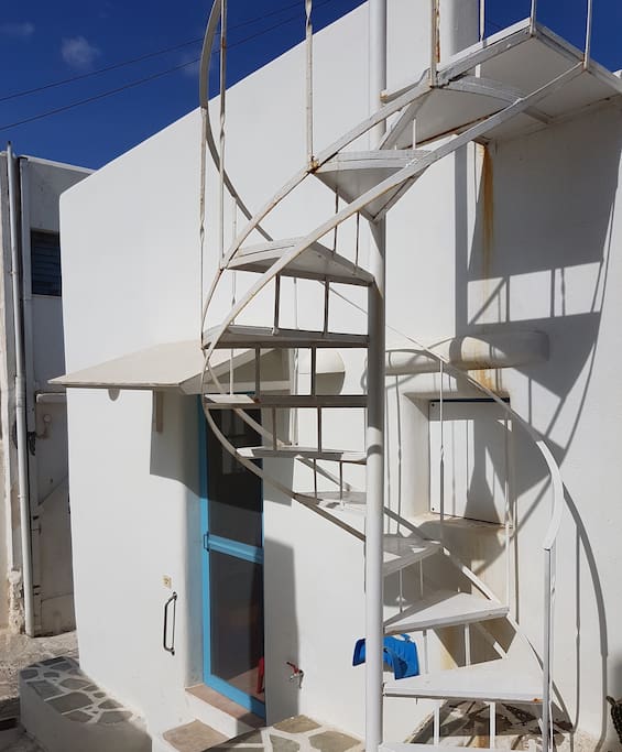 The main entrance to the house, and the ladder leading to the rooftop.