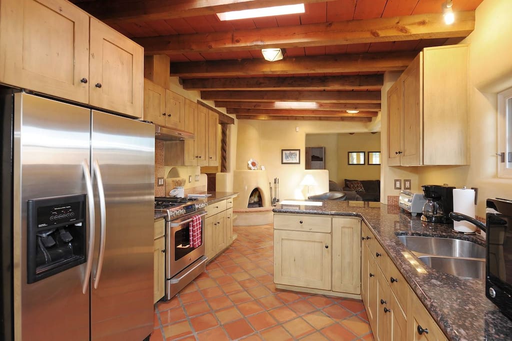 Kitchen with gas stove, toaster, coffee maker, and microwave