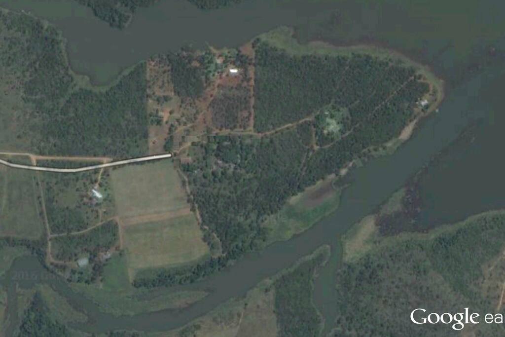 Air photo of site. Island in the Albassinie dam. Campsite on the edge of the water.