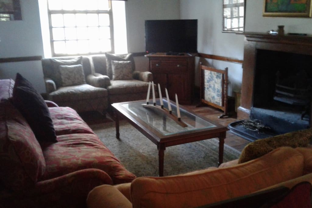 Large comfortable lounge with fireplace and TV/DSTV