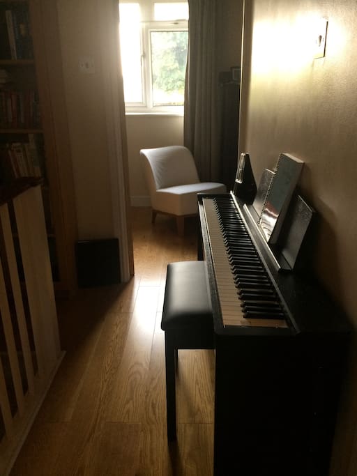 Upper floor landing with a piano