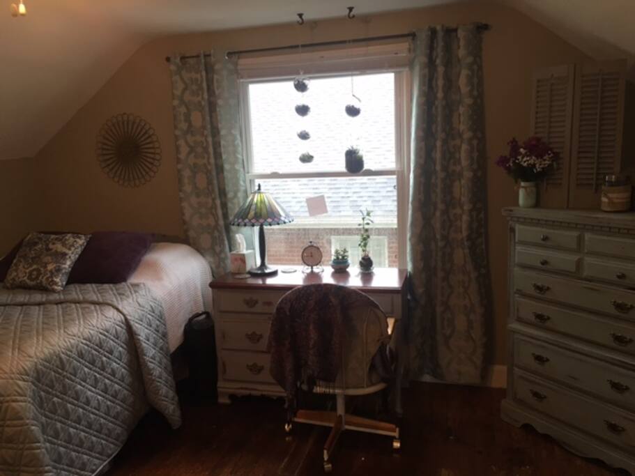 Private bedroom with full sized bed, desk and dresser