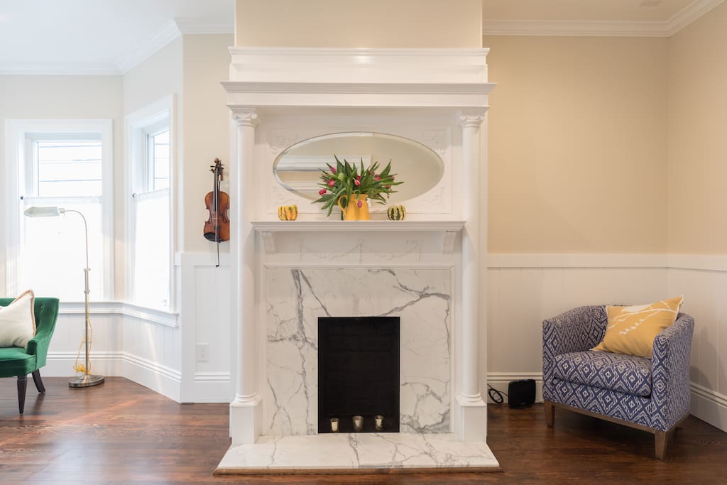 Peaceful, pretty, living room with original fireplace- come and relax after a long day of exploring.