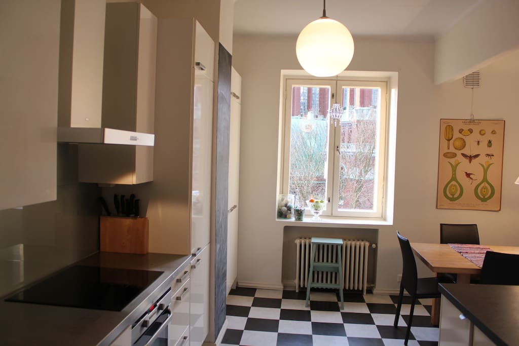 Kitchen is roomy with big dinner table.