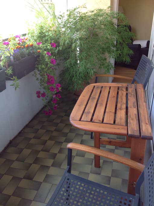 The bedroom has an access to the balcony, where you can have a breakfast