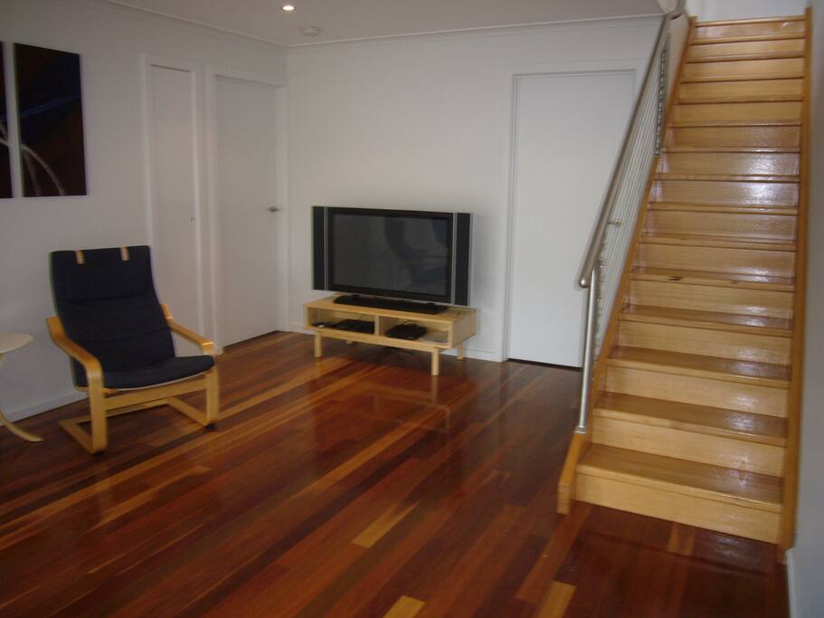 Downstairs living area and staircase leading upstairs