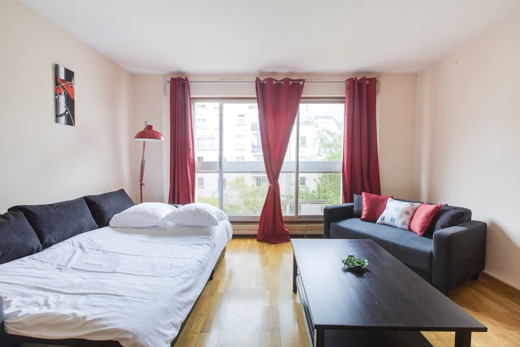 Spacious and bright living room with flat screen TV. Open sofa bed for 2 guests.