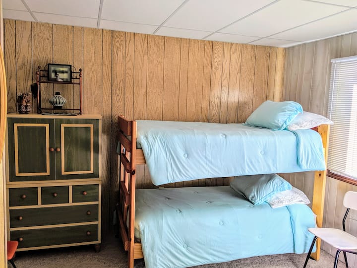 The front bedroom has a comfortable queen bed and a bunk bed.