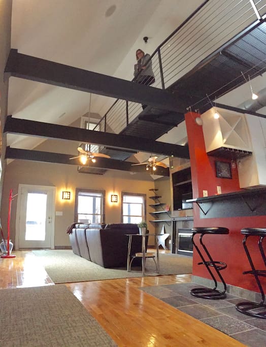 Living room/kitchen with the cat walk above