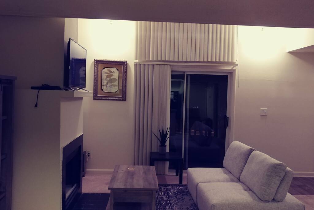 The backs of this couch move back and provide extra room to sleep on for nights that guests may have the whole apartment to themselves. Behind the sliding doors is a spacious balcony.