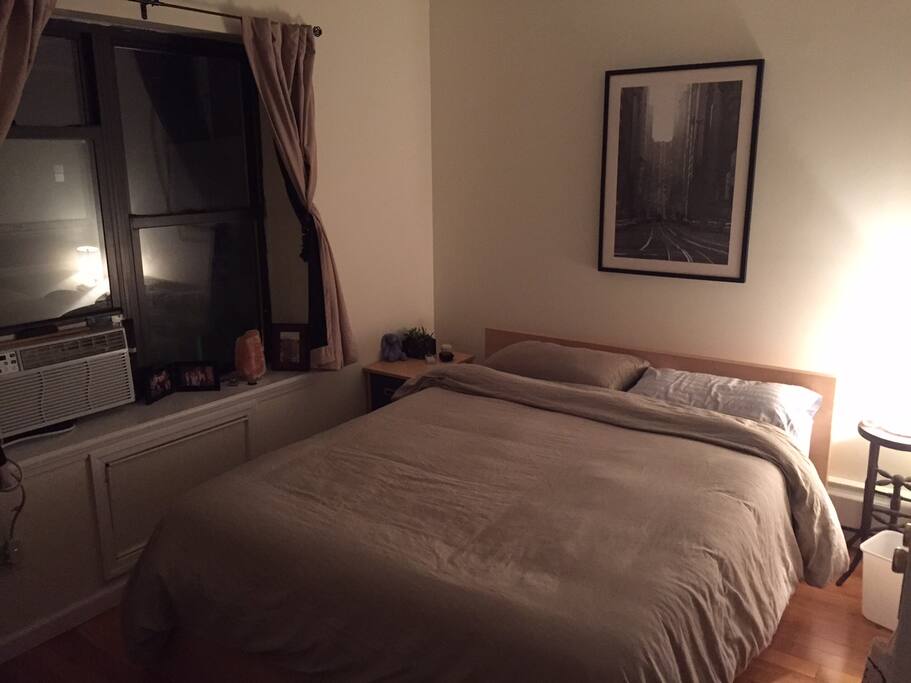 peaceful bedroom with window view but also dark curtains.