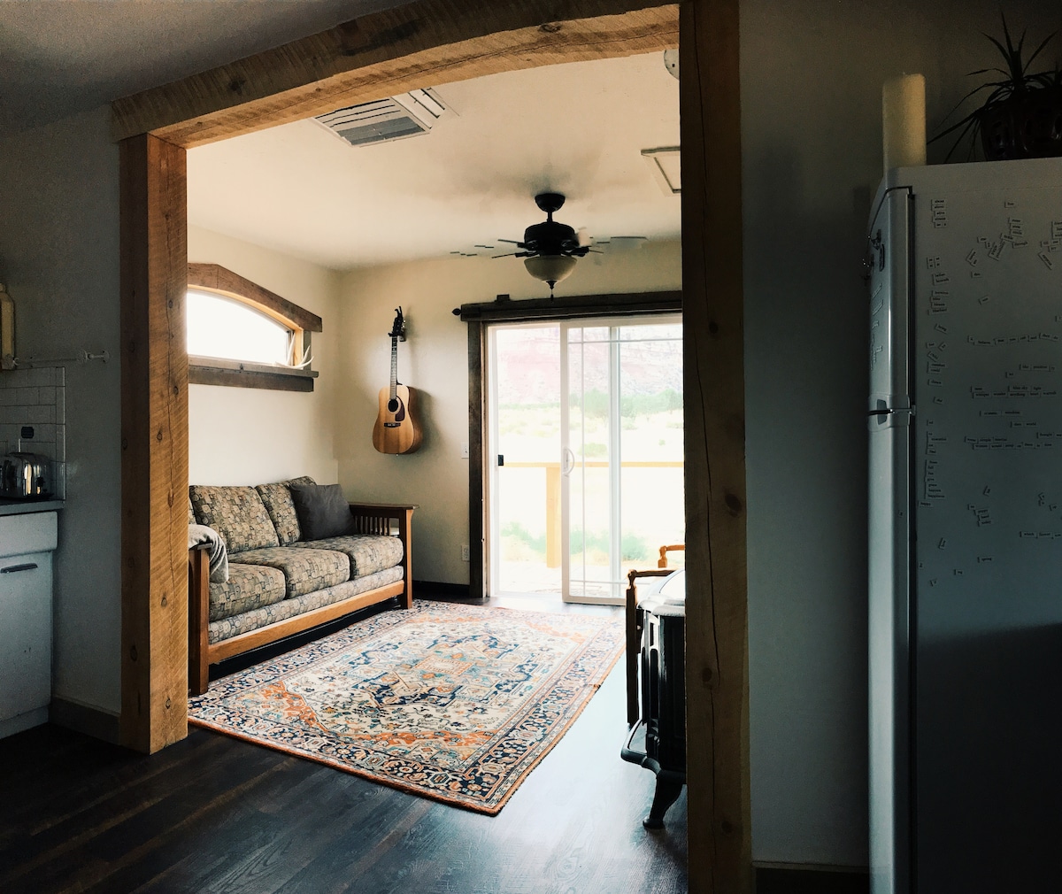 Living room with sliding glass door exit directly onto deck.   You are welcome to use any of our musical instruments! Get creative in your home away from home.