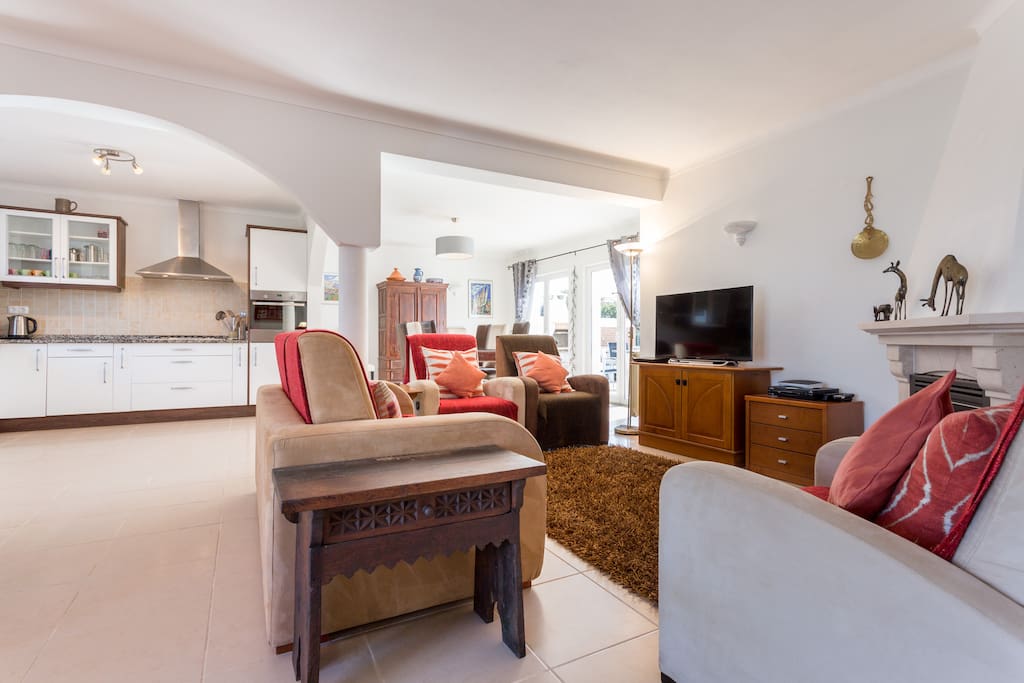 Living room with seating area around the TV and fireplace