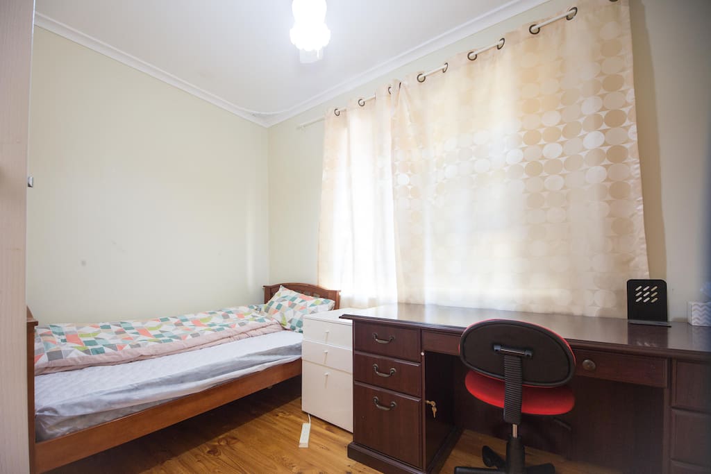 A single bed with working desk in room 2
