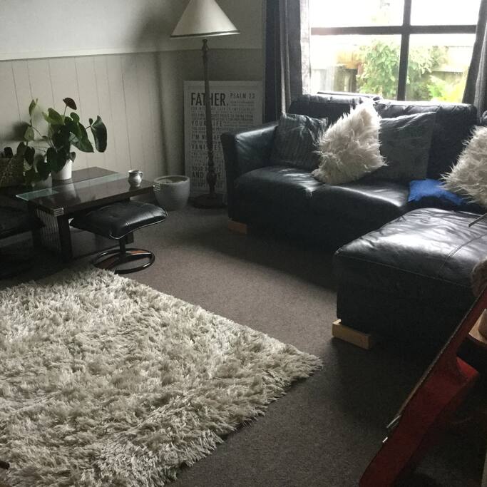 A cozy lounge with tv and fire