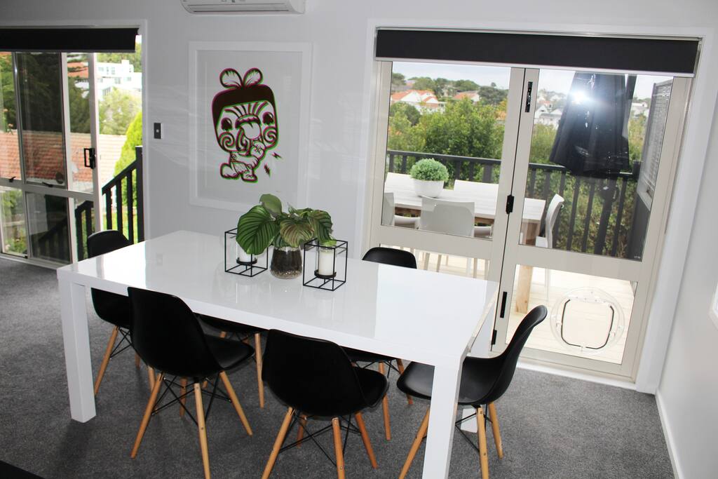 Dining table seats six, with a gorgeous view to outdoor foliage