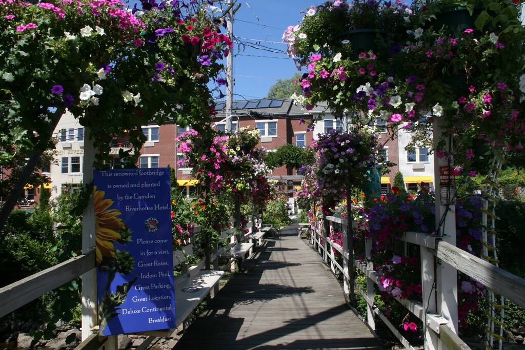 Located across the flower covered footbridge from downtown stores and restaurants