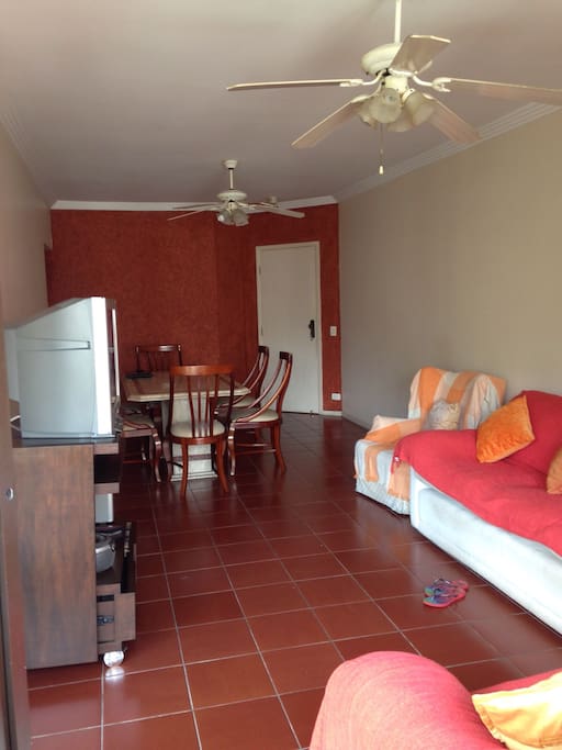 Sala Ampla com 2 sofás confortáveis, TV e mesa para 8 lugares