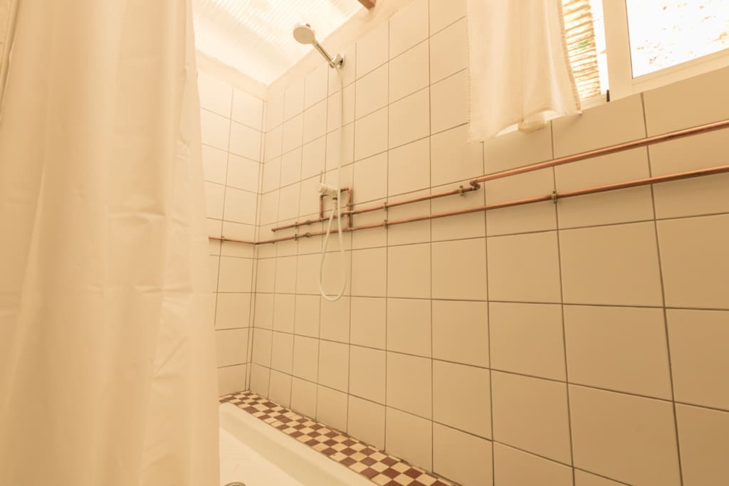 The shower room has copper pipes decorating the walls. When guests are using the shower they can hang their towels on the "hot" pipe and the towel will warm up.