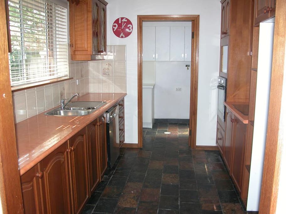 Shared galley kitchen, with access to courtyard, laundry and toilet.