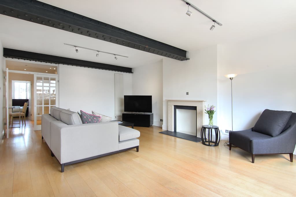 The luxurious Lounge area with feature fireplace and exposed beams.