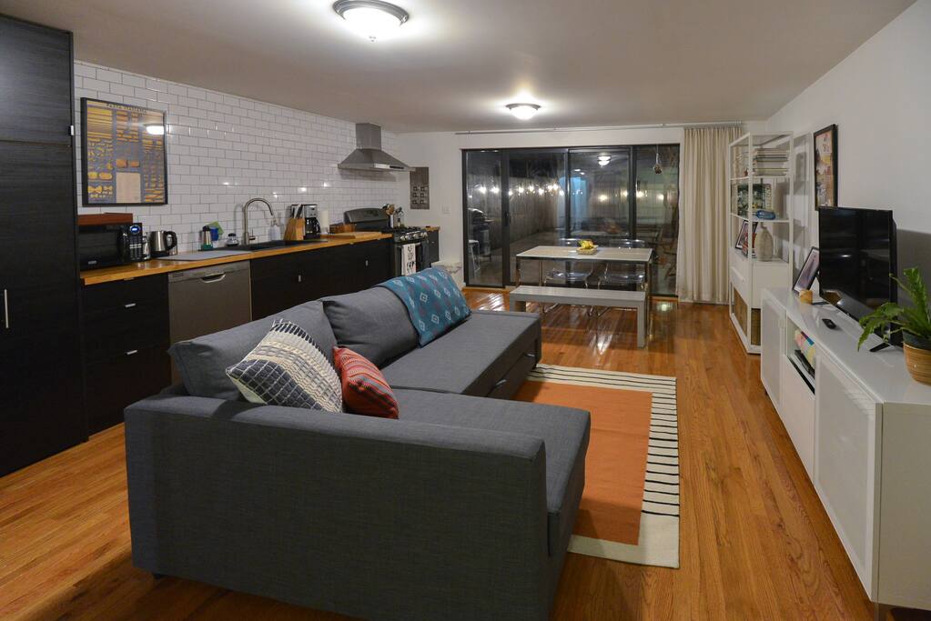 Living room at night, opens onto backyard
