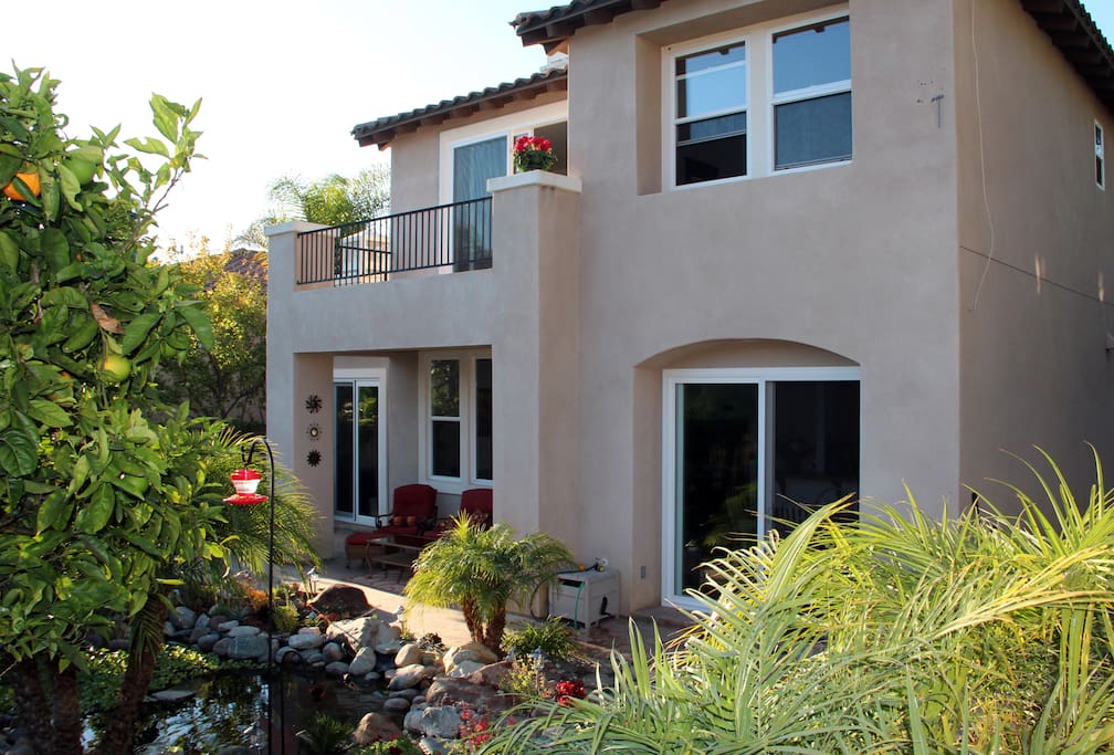 Back of our home; note the sitting area next to one of the two large ponds.