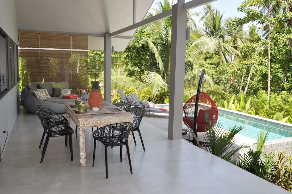 Contemporary outdoor dining on the terrace overlooking the pool
