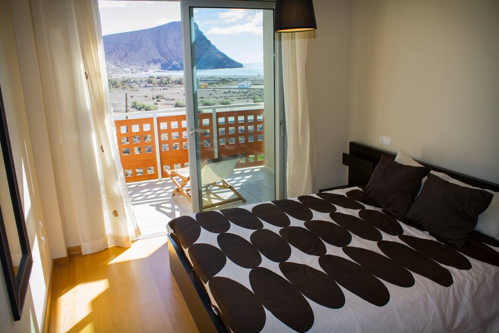 master bedroom with private terrace and views