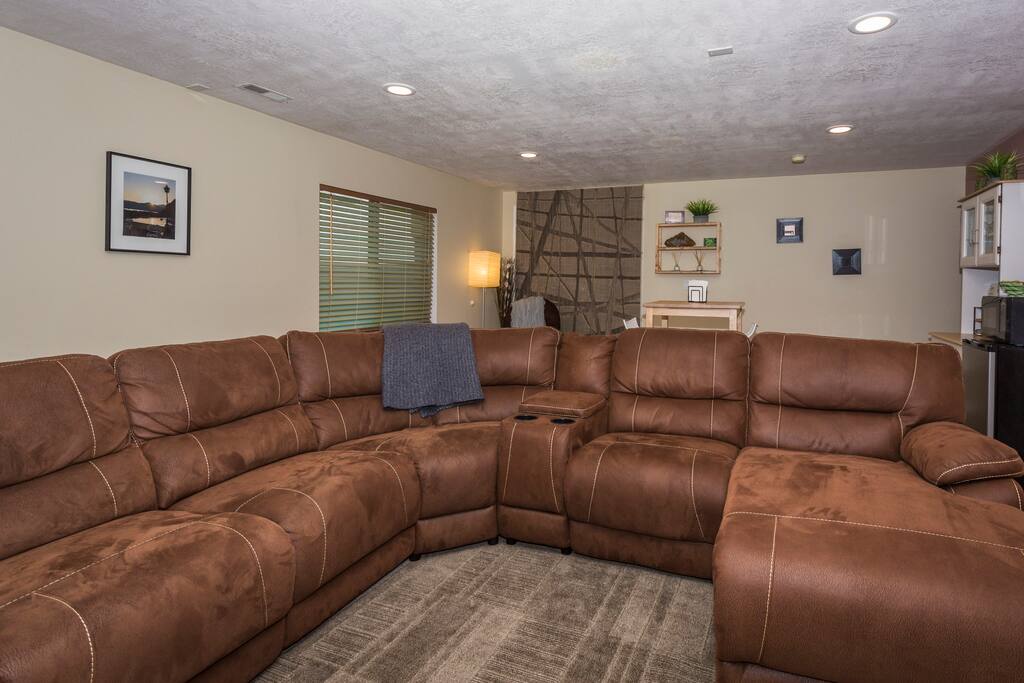 Large wrap-around couch with 2 reclining legs and Chaise lounge.