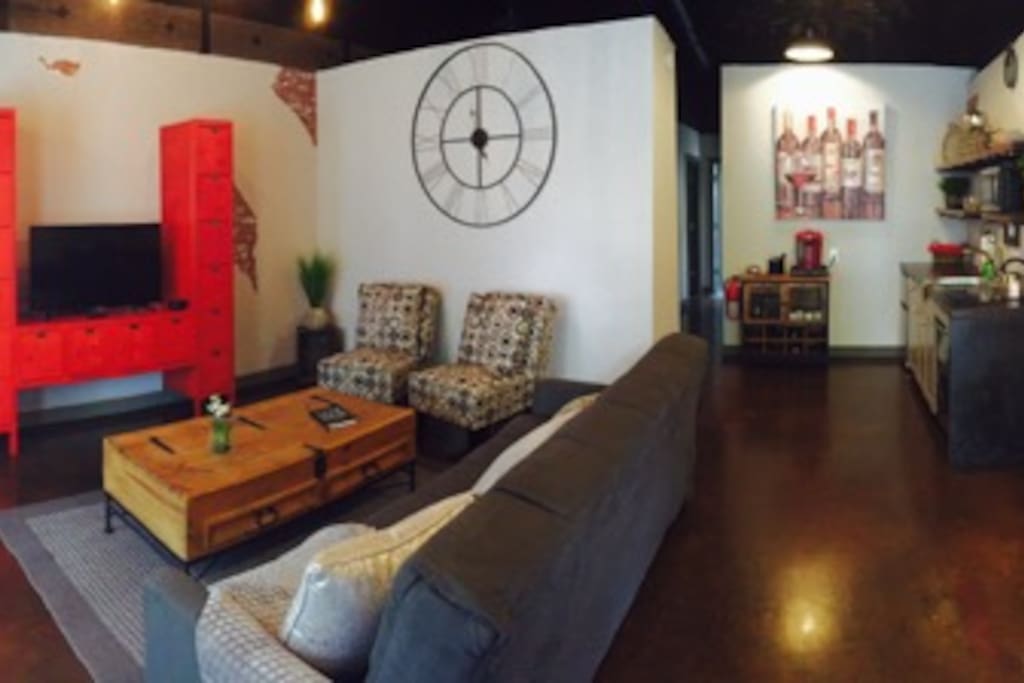 Panoramic view of the living room, kitchen and work space