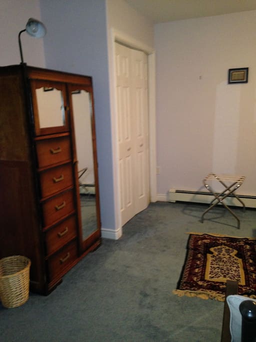 Vintage dresser with mirrors and luggage stand. Double size closet with ample supply of clothes hangers.