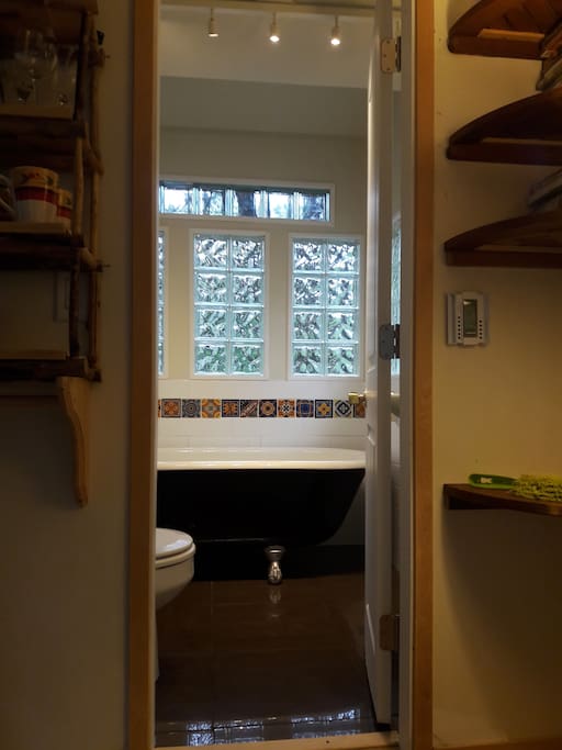 Solarium bathroom with clawfoot tub, heated floors and unlimited hot water.