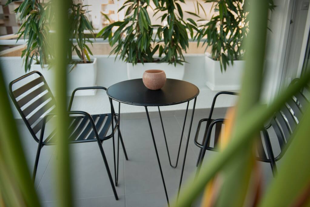 Two large Verandas lined with plants and furniture.
