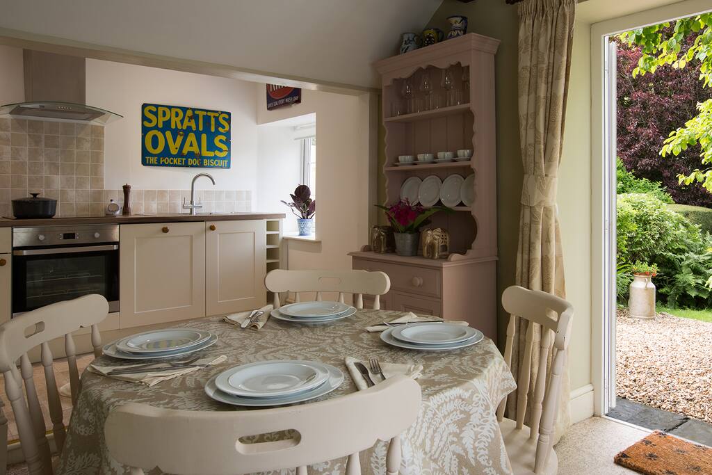 Dining room and kitchen with double doors to private garden and outside seating.