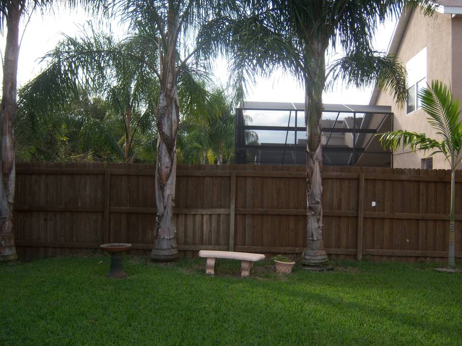 view of the backyard that is surrounded by a 8 foot gate