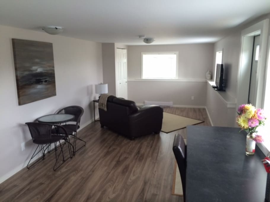 Cozy living room (with cable TV), dining room and work station.
