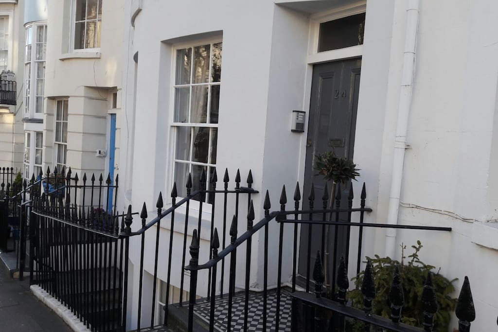 There are just 2 steps up to the smart grey front door, the apartment is on the ground floor