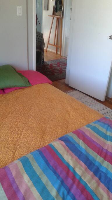 low bed; throw rugs