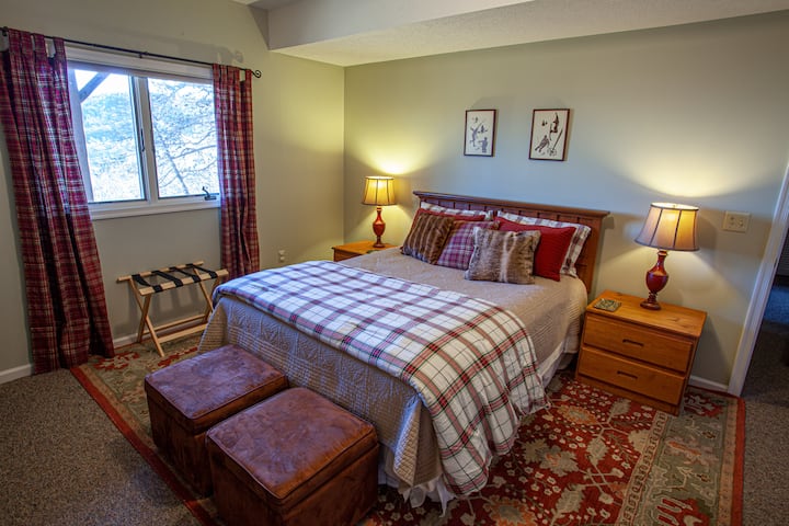 Master Bedroom Three: Spacious bedroom with mountain views and a private ensuite bathroom, offering comfort and privacy for a restful stay.