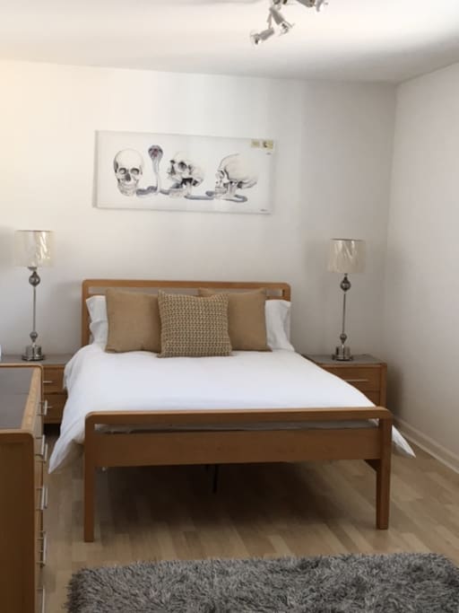 Spacious double bedroom with ample storage including fitted wardrobes.