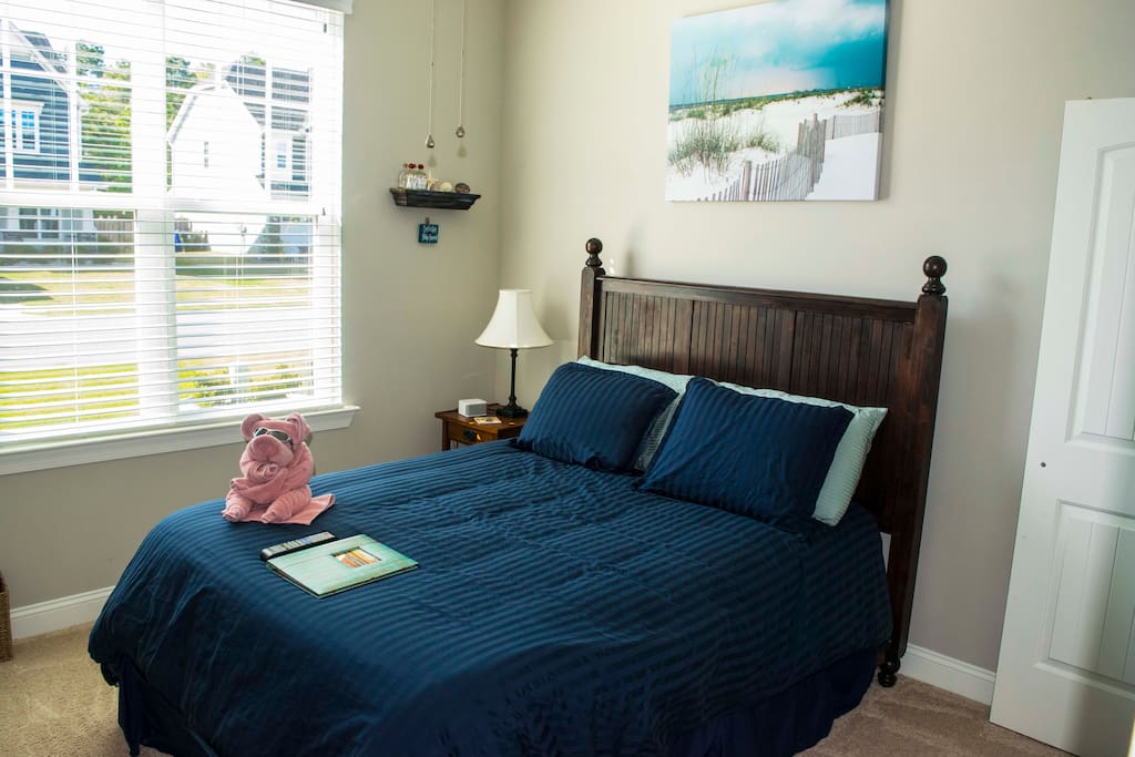 Queen-sized bed with view of the front of the house. Your welcome binder will help you find everything you need to make your stay memorable.