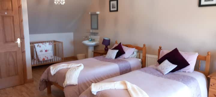 Ზემოთ ტყუპი საძინებელი ხელსაბანით და ბავშვის საწოლით