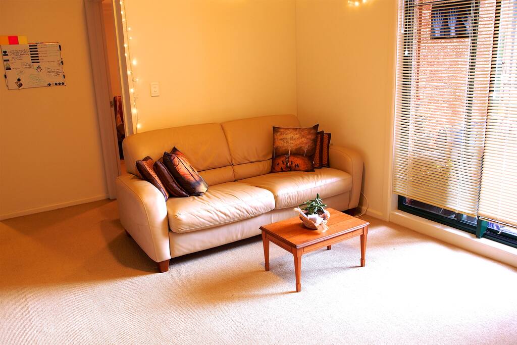 Sofa, and behind is the entrance to the bedroom, and a whiteboard to write notes on...