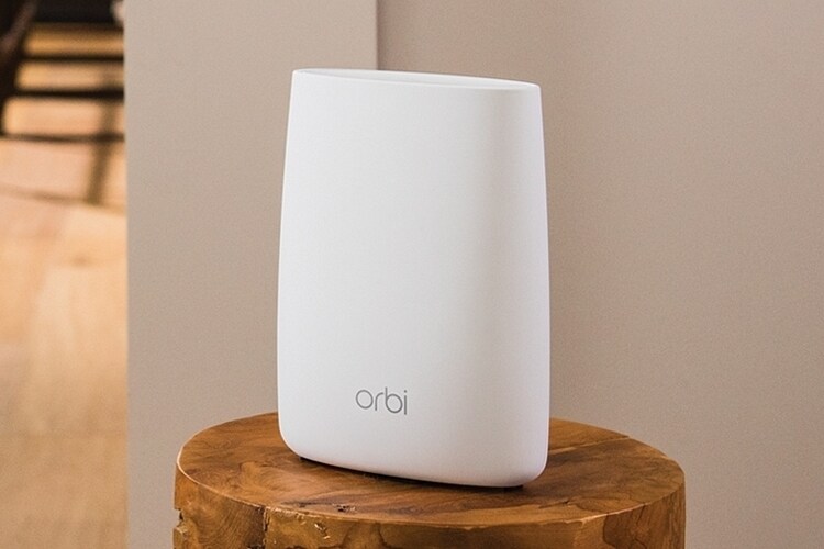 A sleek white router is placed on a wooden pedestal, contributing to a modern aesthetic. The device features smooth contours and a minimalist design, ensuring a seamless blend with the surrounding decor.