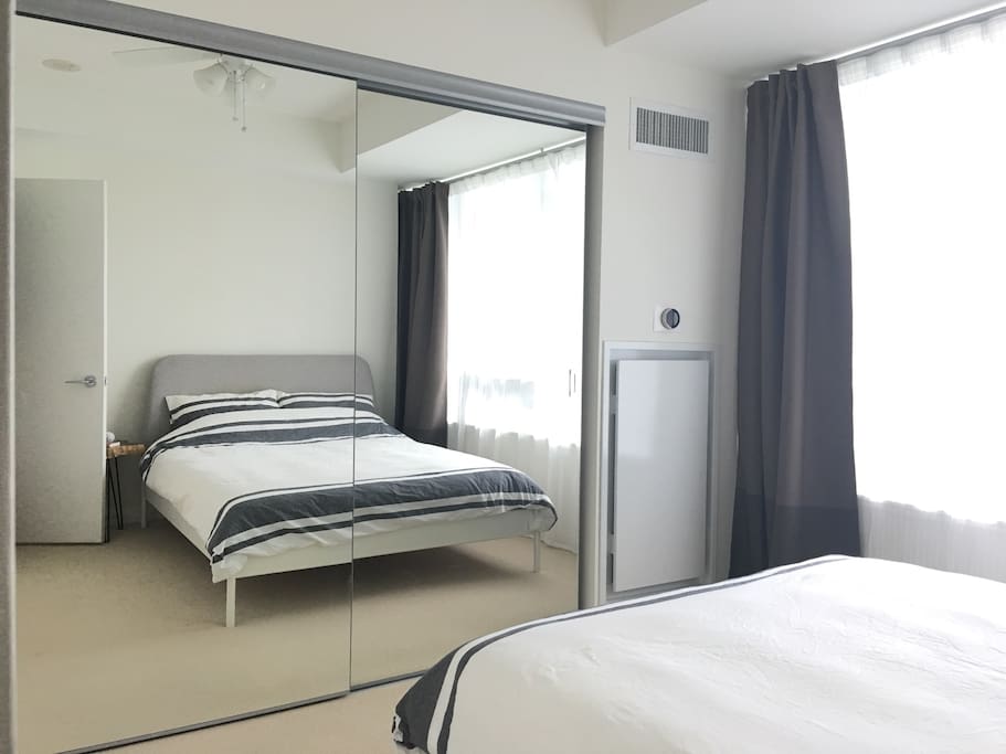 Queen-sized bed in a quiet bedroom overlooking the yard