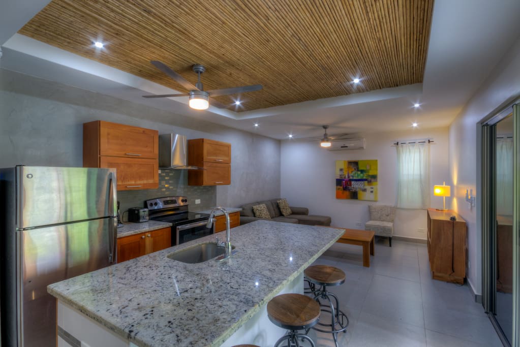 Full kitchen, large island area with seating for four people.
