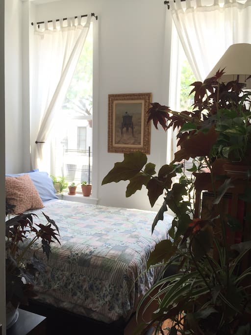 View of the sun filled guest room. Two large windows with high ceilings. Brand new Sealy posturpedic full size bed with goose down pillows, fresh linens and blankets.
