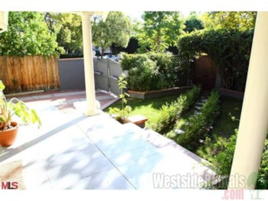 Front porch/garden with al fresco dining area .
