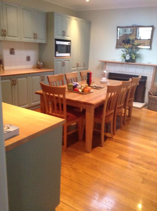 Open country style kitchen with wood heater and icemaker